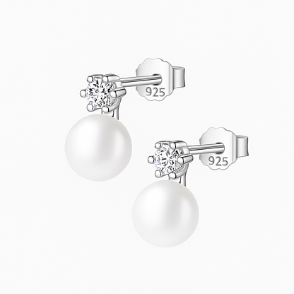 Pair of pearl earrings with silver studs on a white background
