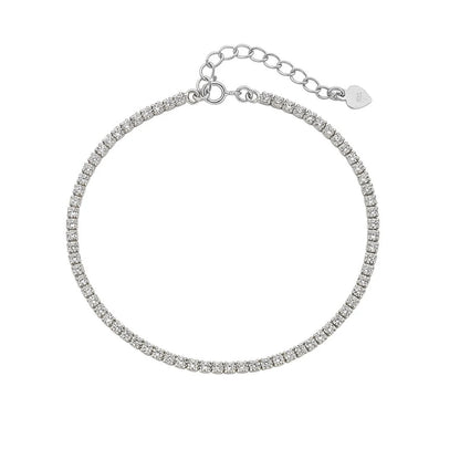 Flat lay image of a sterling silver children's bracelet with a clear CZ tennis bracelet design and an extension, featuring a lobster clasp.