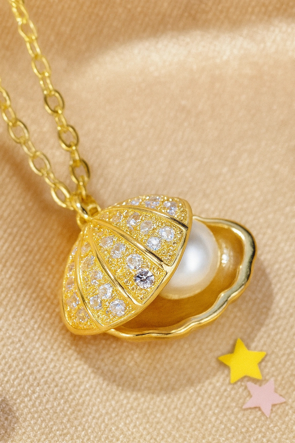 Locket Necklace - Surgical Steel Gold IP Shell CZ Pearl Locket with sparkling cubic zirconia and synthetic pearl inside.