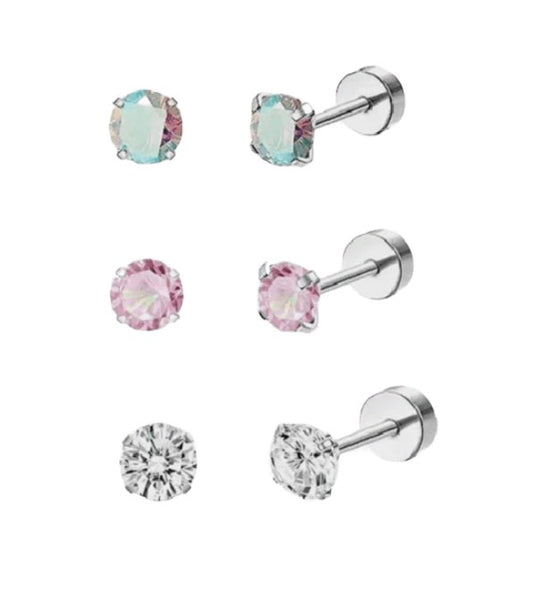 A set of three pairs of baby and children's earrings, featuring surgical steel round studs in silver, pink, and clear colors, each with screw back closures.