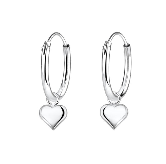 a pair of sterling silver children's sleeper earrings with tiny heart charm dangles on a white background