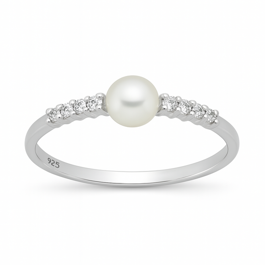A polished sterling silver ring displayed on a white background, featuring a round white pearl at its centre flanked on each side by three small round cubic zirconia stones set into the slender band.