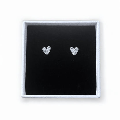 Heart-shaped silver earrings in a white gift box with black velvet lining on a white background