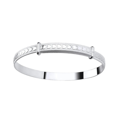 A sterling silver children's bangle with embossed hearts and a bead border, adjustable closure.