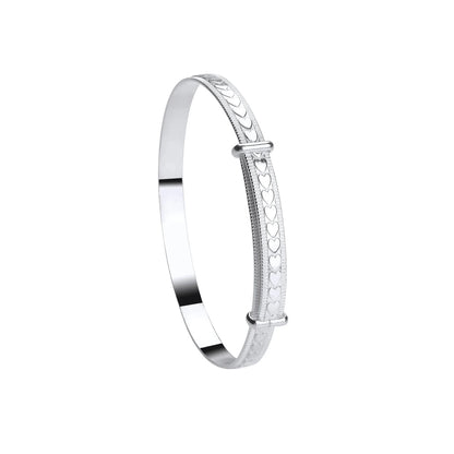 A sterling silver children's bangle with embossed hearts and a bead border, adjustable closure.