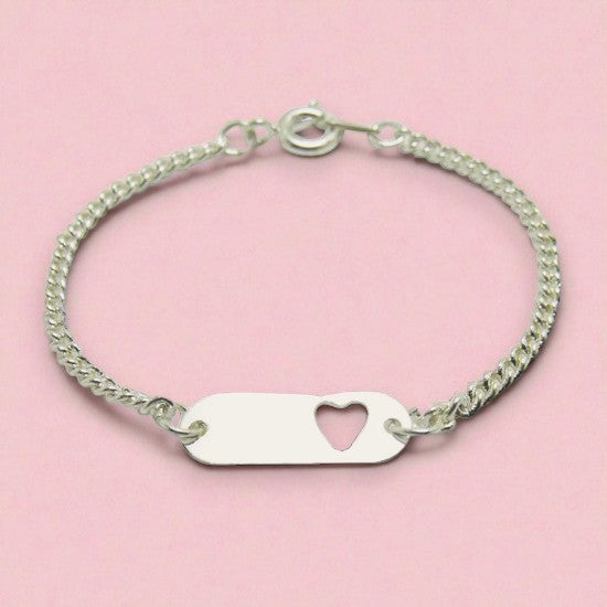 Silver bracelet with a heart-shaped tag on a pink background