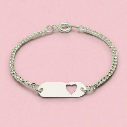 Silver bracelet with a heart-shaped tag on a pink background