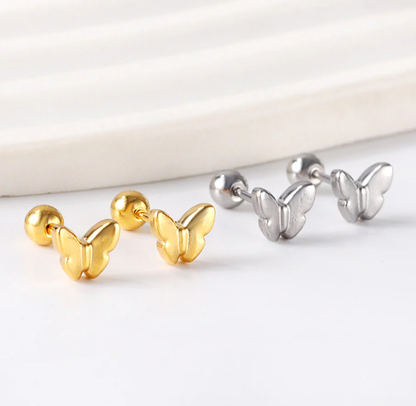 Gold and silver butterfly-shaped earrings on a white background