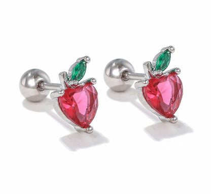 Pair of earrings with red heart-shaped stones and green leaves on a white background