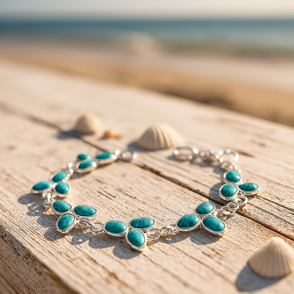 Turquoise bracelet on a wooden surface with shells, against a blurred beach background