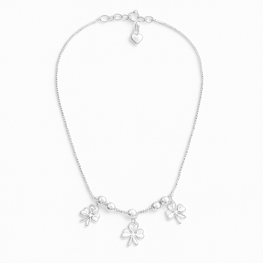 sterling silver clover charm anklet on a white background
