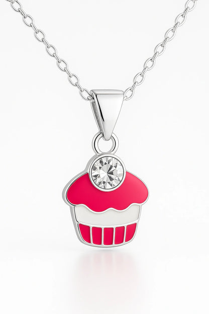 Close-up of sterling silver cupcake pendant showing pink enamel detail and sparkling crystal