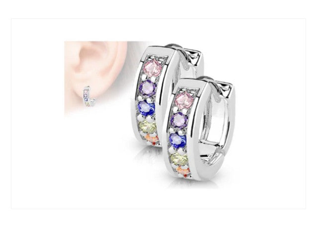 A pair of children's earrings featuring surgical steel with multicolored cubic zirconia huggies.