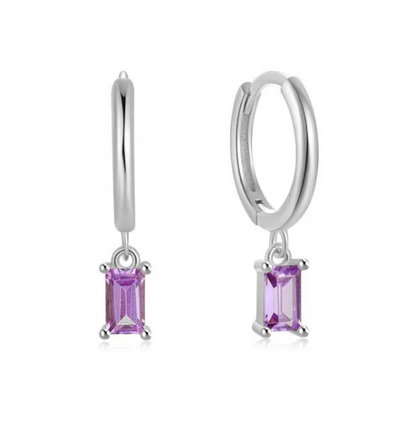 A pair of sterling silver hoop earrings with dark lavender cubic zirconia charms attached, displayed against a white background.