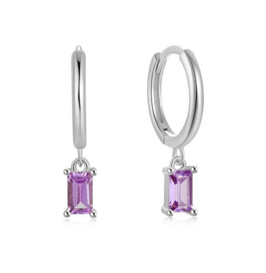 A pair of sterling silver hoop earrings with dark lavender cubic zirconia charms attached, displayed against a white background.