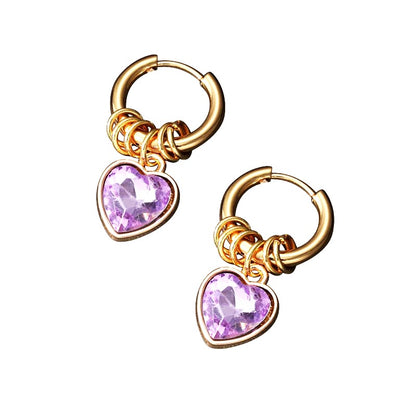 gold plated steel hoops with ring charms and purple amethyst cz heart dangles on a white background