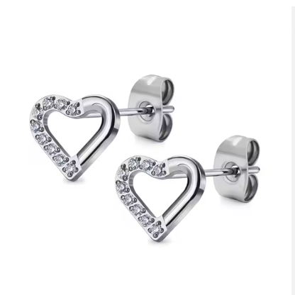 Heart-shaped silver earrings with clear gemstones on a white background