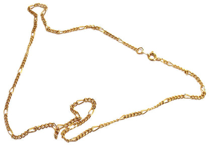Delicate gold-plated Figaro chain bracelet on a white background, featuring alternating short links and an elongated oval link with a spring-ring clasp.