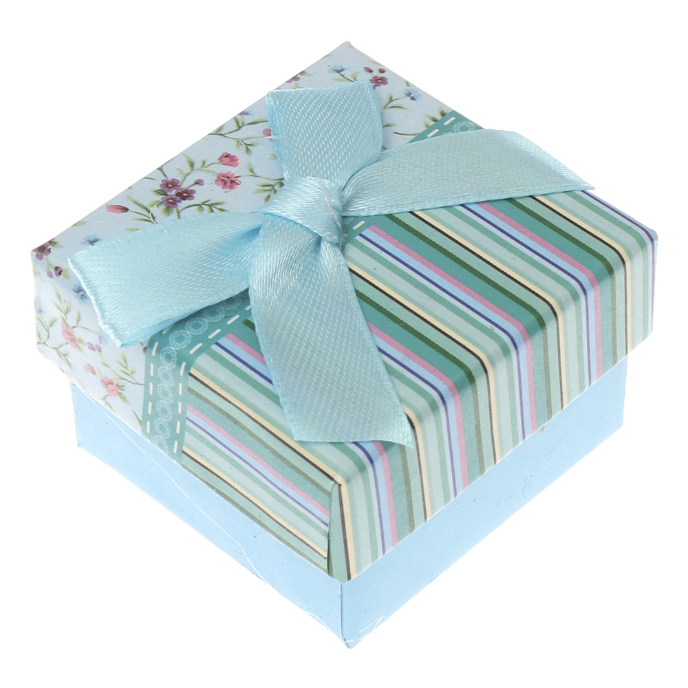 Small floral gift box with blue ribbon, ideal for presenting jewellery or rings, featuring a stylish design.