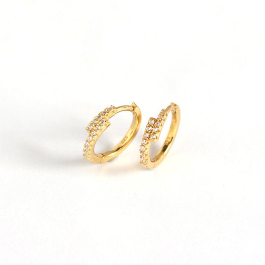 gold plated sterling silver hoops with cubic zirconia in an overlapping design on a white background