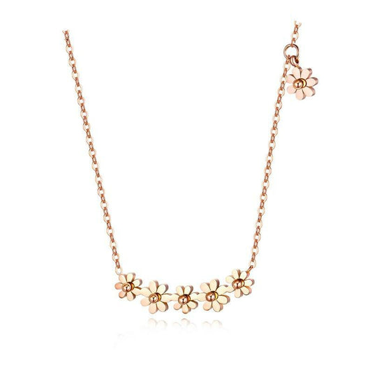Daisy necklace made of titanium with rose gold IP plating, featuring multiple daisy charms on a chain.