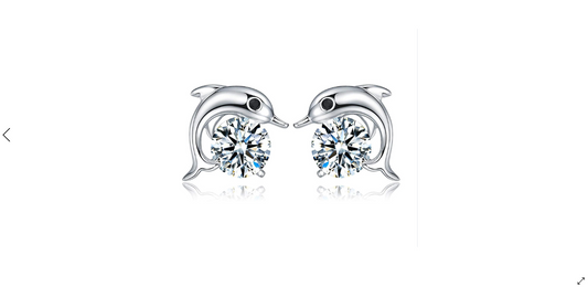 A pair of sterling silver children's earrings featuring dolphin shapes with cubic zirconia accents.