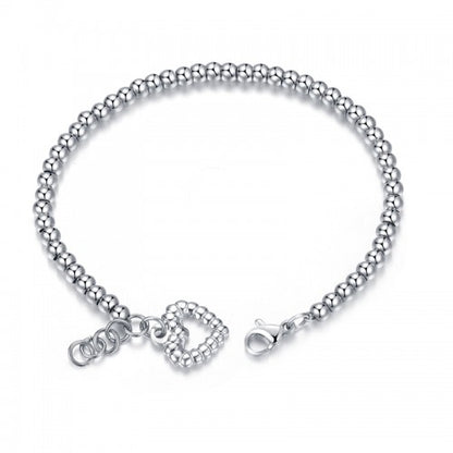 Titanium bracelet with polished ball beads and heart charm, showcasing elegant design and hypoallergenic properties.