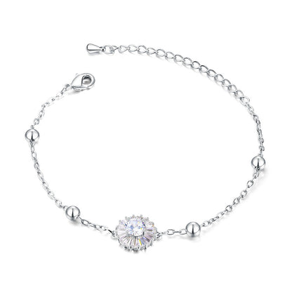 Delicate titanium steel bracelet with cubic zirconia flower centerpiece and polished steel balls.