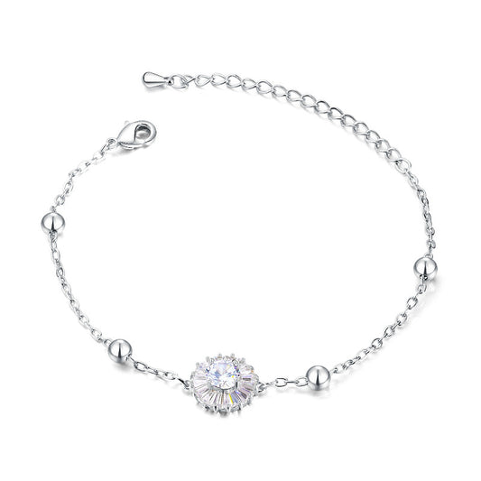 Delicate titanium steel bracelet with cubic zirconia flower centerpiece and polished steel balls.