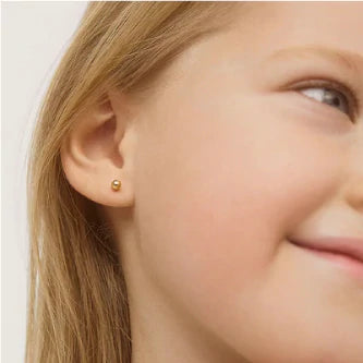 Gold ball stud earrings showcased on a girl, highlighting the elegant 4mm solid gold design and screw back closure.