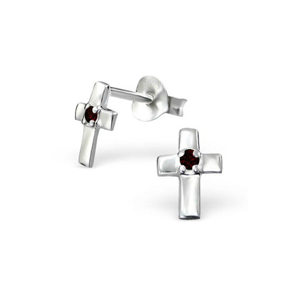 A pair of sterling silver tiny cross earrings with garnet cz stones and push backs on a white background