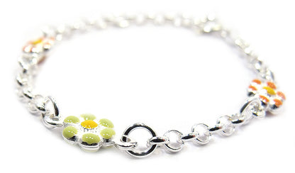 close up detail of a sterling-silver chain bracelet on a pure white background, featuring three enamel daisy charms—two with orange petals and one with pale green petals—linked by oval silver chain links and finished with a lobster-clasp closure.