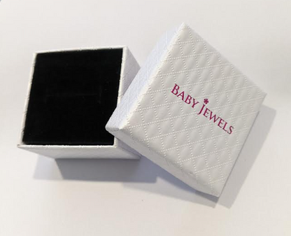 a white quilted Baby Jewels gift box with black velvet insert on a white background