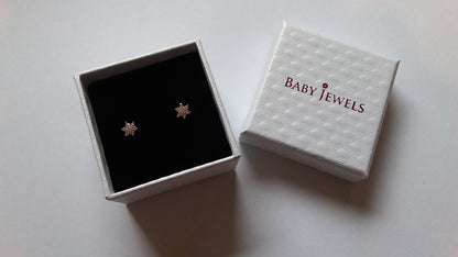a white quilted gift box with pink baby jewels logo on the lid and black velvet lining on a white background