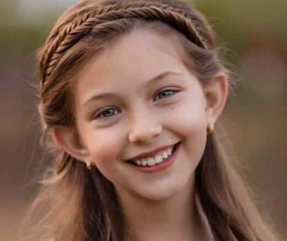 CZ huggies in gold surgical steel with white AAA CZ worn by a young girl, showcasing sophistication and elegance.