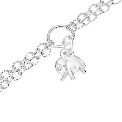 Close up of an elephant charm on a silver children's double chain charm bracelet on a white background