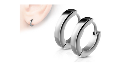 Pair of small polished silver-tone stainless steel hinged hoop earrings displayed side by side, with an inset close-up showing one earring worn on a right earlobe