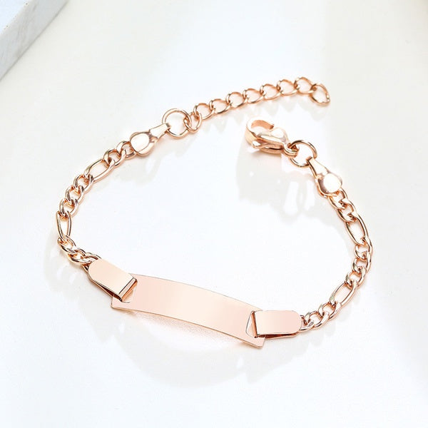A rose gold-coloured surgical steel baby bracelet with an extender chain and a polished finish, displayed on a white surface.