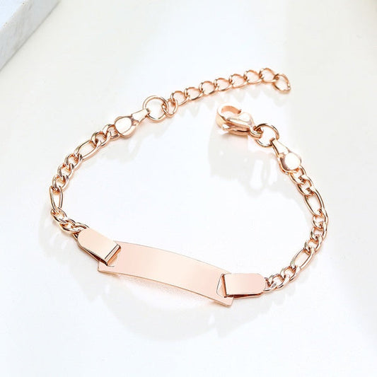 A rose gold-coloured surgical steel baby bracelet with an extender chain and a polished finish, displayed on a white surface.