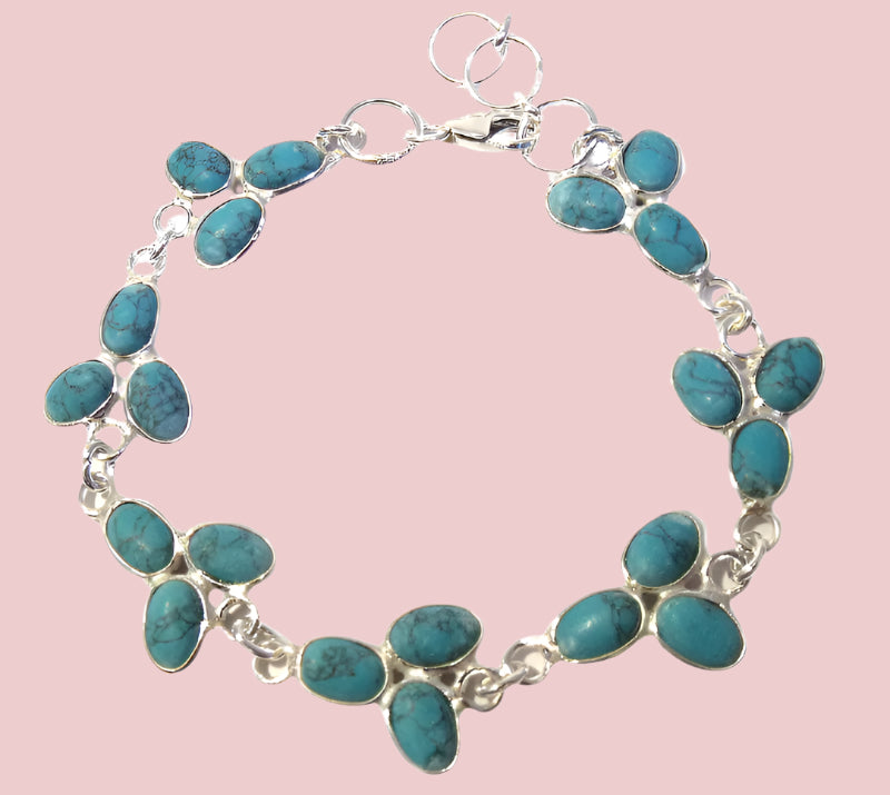 Turquoise bracelet with silver links on a light pink background